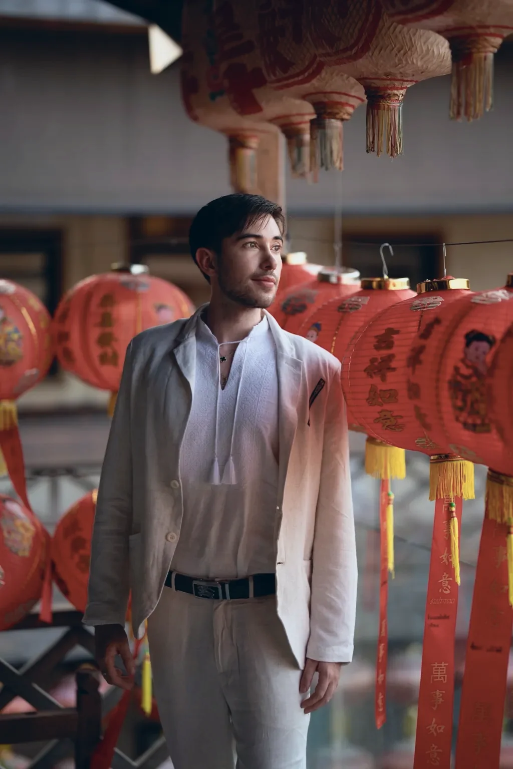 Alexander Weiskopf in a light suit among red lanterns